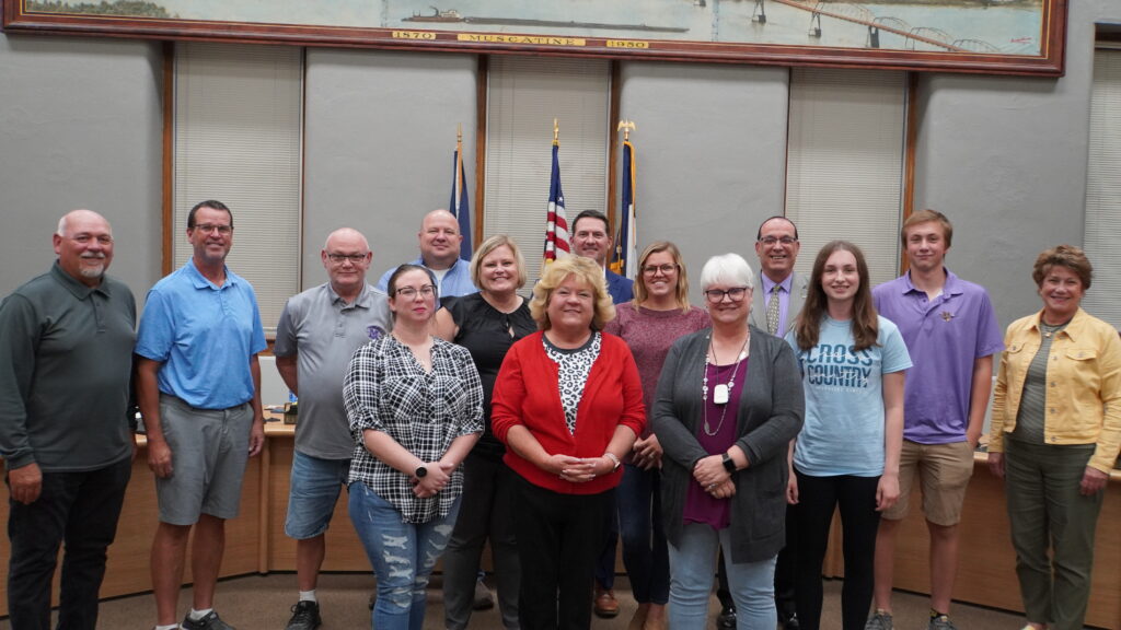 Picture from the Monday, September 11, 2023 school board meeting with two paraeducators recognized. Others in the photo include all school board members, superintendent, student school board reps and the assistant to the superintendent. 